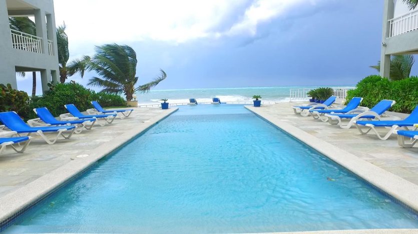 Swimming Pool & Beah Chairs in the front of Ocean